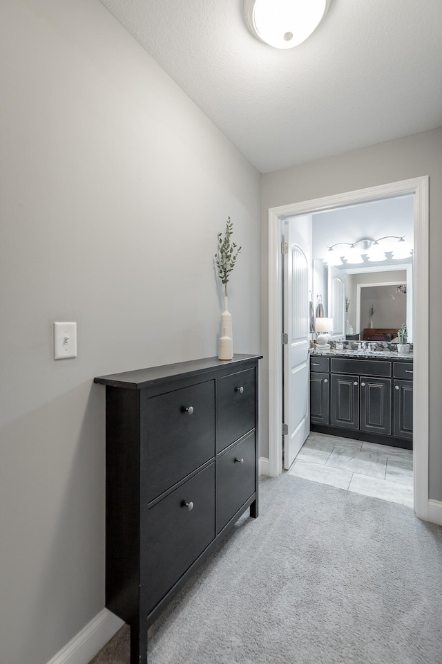 interior space with tile patterned floors, a textured ceiling, and vanity