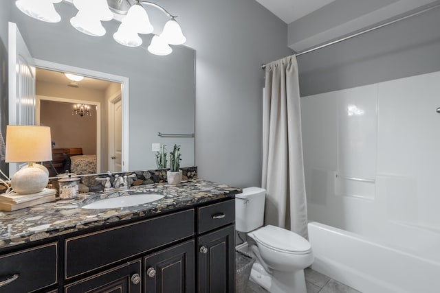 full bathroom with tile patterned floors, toilet, a notable chandelier, shower / bath combo with shower curtain, and vanity