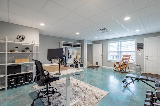 office with concrete floors and a drop ceiling