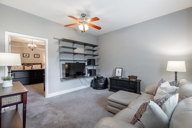 carpeted living room featuring ceiling fan with notable chandelier