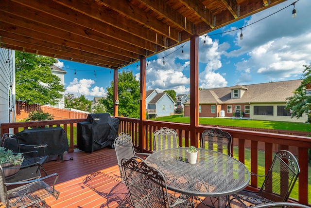 deck with grilling area and a yard