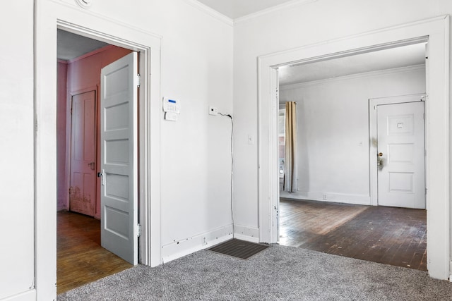 hallway with dark wood-type flooring and ornamental molding