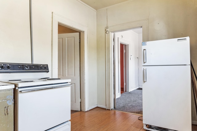 kitchen with light wood-type flooring, white appliances, and ornamental molding