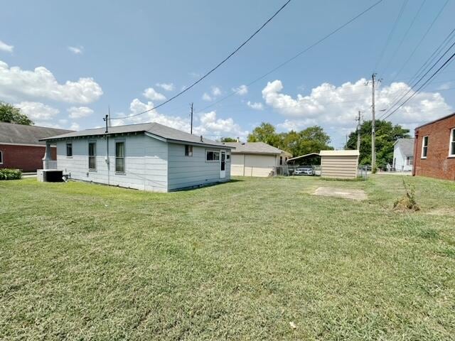 view of yard with cooling unit and a storage shed