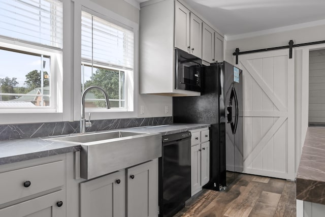 kitchen featuring a healthy amount of sunlight, crown molding, black appliances, and dark hardwood / wood-style floors