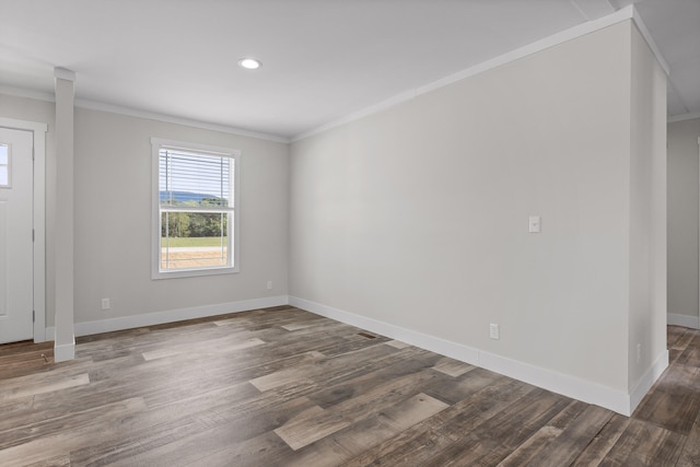 spare room featuring dark hardwood / wood-style floors and ornamental molding