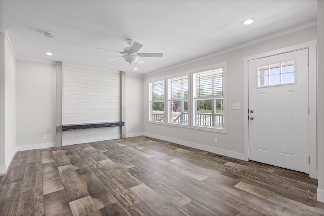 foyer featuring ornamental molding, a healthy amount of sunlight, ceiling fan, and wood-type flooring