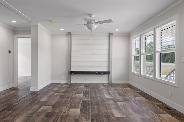 unfurnished room featuring ornamental molding, ceiling fan, and dark wood-type flooring