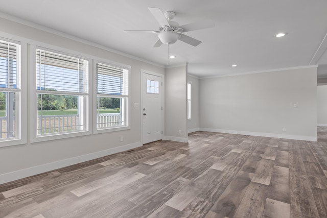 interior space featuring crown molding, light wood-type flooring, and ceiling fan