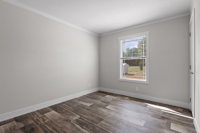 spare room featuring dark hardwood / wood-style floors and ornamental molding