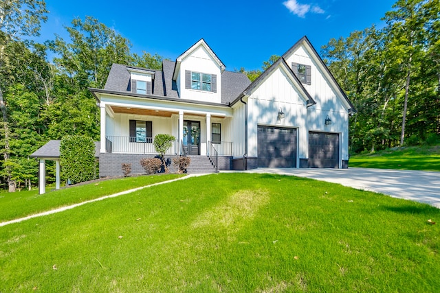 view of front facade featuring a garage, a front yard, and a porch