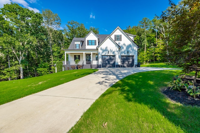 view of front of house with a garage, a front yard, and a porch