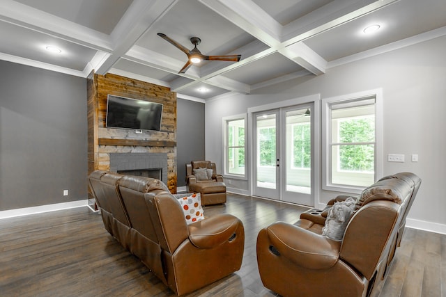 living room with ceiling fan, dark hardwood / wood-style floors, and a stone fireplace