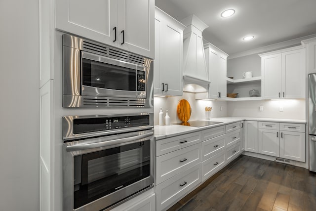 kitchen with white cabinets, stainless steel appliances, and dark hardwood / wood-style flooring