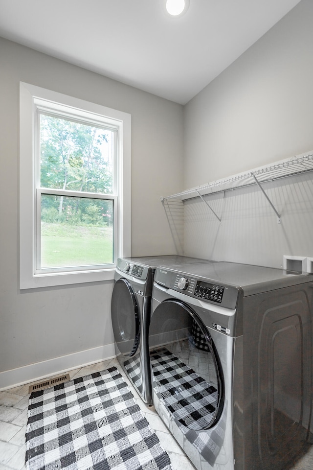 washroom with plenty of natural light and independent washer and dryer