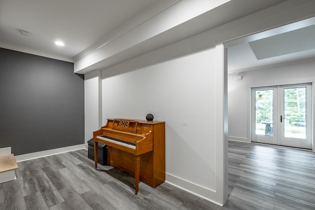 interior space with crown molding, french doors, and hardwood / wood-style flooring