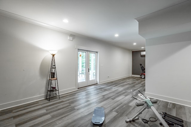 empty room with ornamental molding, french doors, and wood-type flooring