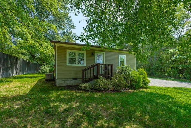 view of front facade with a front lawn and central AC