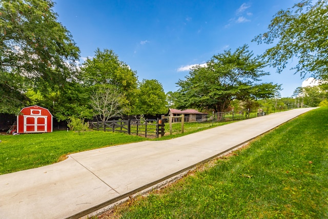 view of home's community featuring a storage shed and a lawn