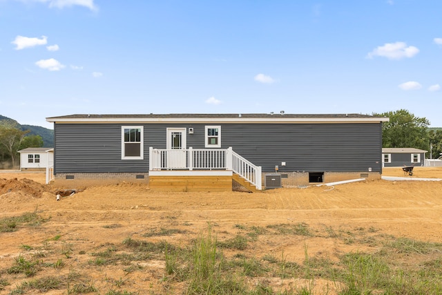 back of house featuring cooling unit and a deck