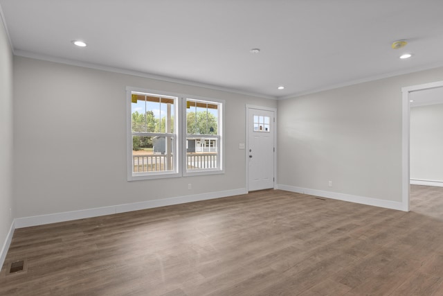 interior space featuring crown molding, a baseboard radiator, and wood-type flooring