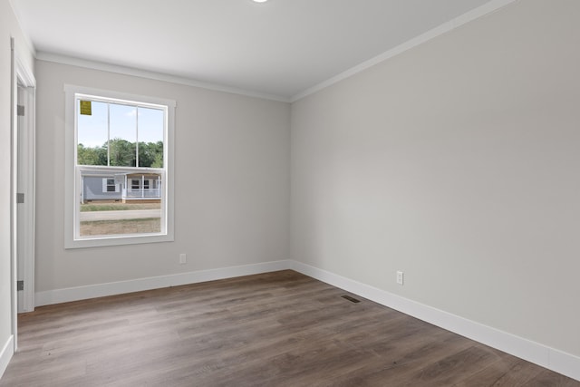 unfurnished room with hardwood / wood-style flooring and crown molding