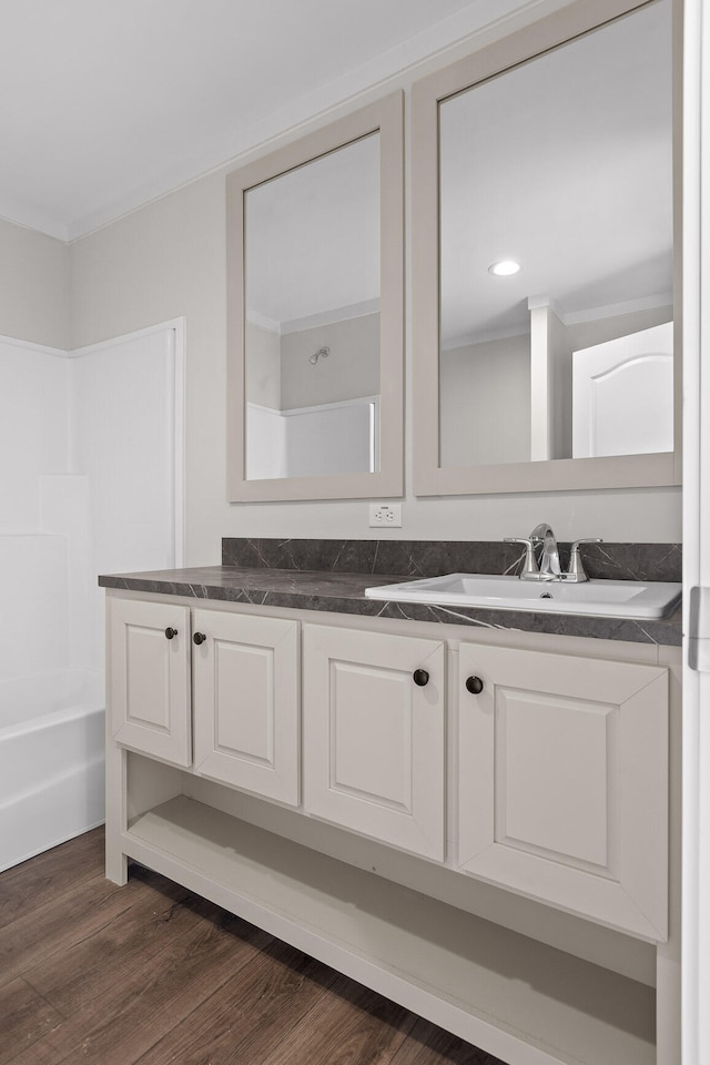 bathroom featuring shower / bathtub combination, vanity, and wood-type flooring