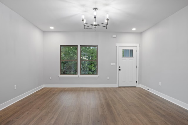 interior space with hardwood / wood-style floors and a notable chandelier