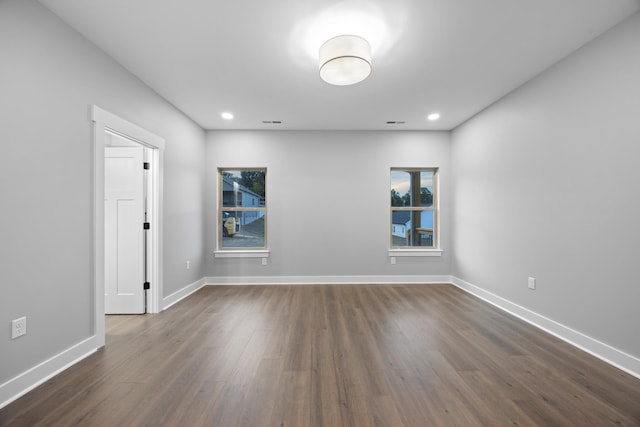 unfurnished room with dark hardwood / wood-style floors