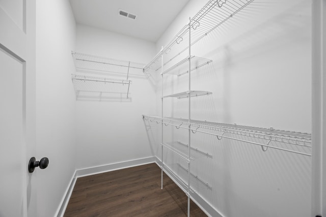 spacious closet with dark hardwood / wood-style floors