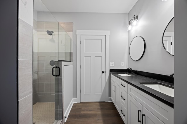 bathroom with hardwood / wood-style floors, an enclosed shower, and vanity