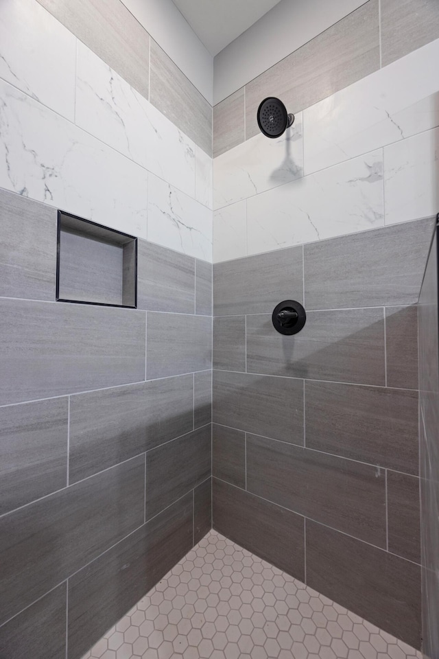 bathroom with tiled shower