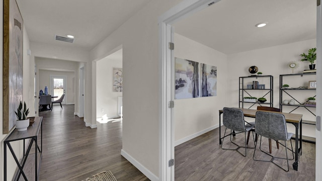 home office with dark hardwood / wood-style flooring