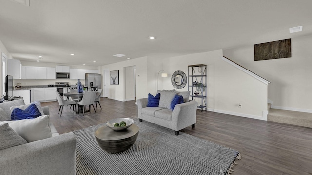 living room with dark hardwood / wood-style flooring