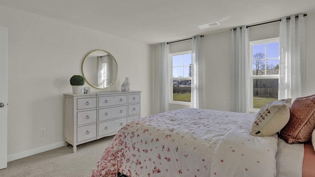 carpeted bedroom featuring multiple windows