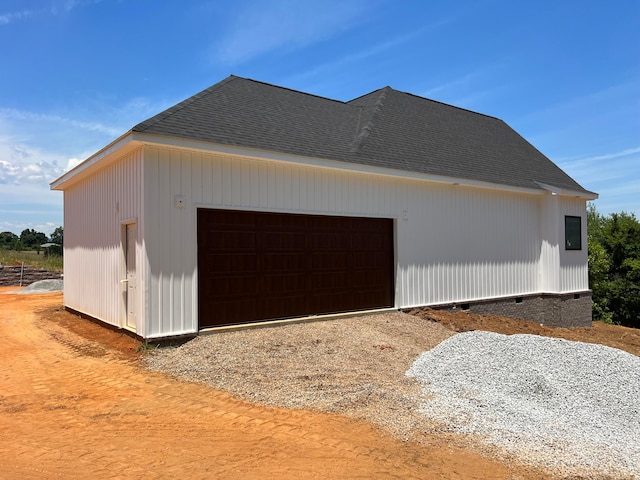 view of side of property featuring an outdoor structure and a garage