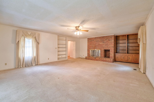 unfurnished living room featuring a fireplace, light carpet, a textured ceiling, and ceiling fan