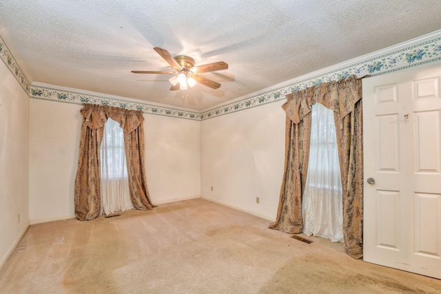 empty room featuring light carpet, a healthy amount of sunlight, and ceiling fan