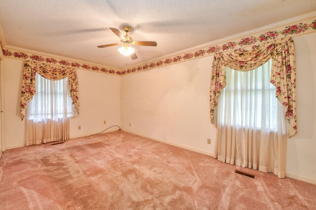 unfurnished room with ornamental molding, a textured ceiling, ceiling fan, and carpet flooring