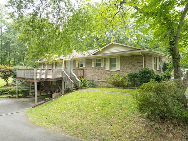 exterior space with a deck and a front lawn