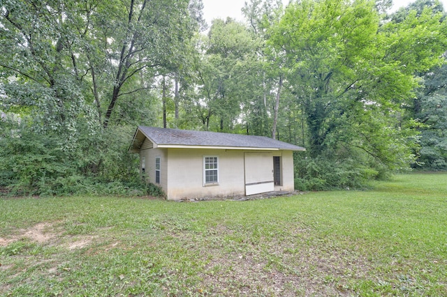 view of outbuilding with a yard