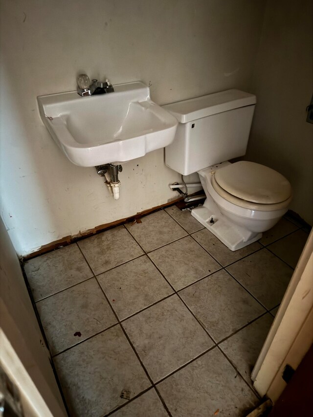 bathroom with tile patterned flooring, toilet, and sink