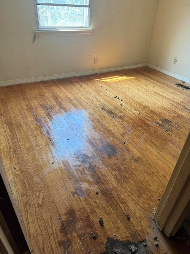 unfurnished room with hardwood / wood-style floors