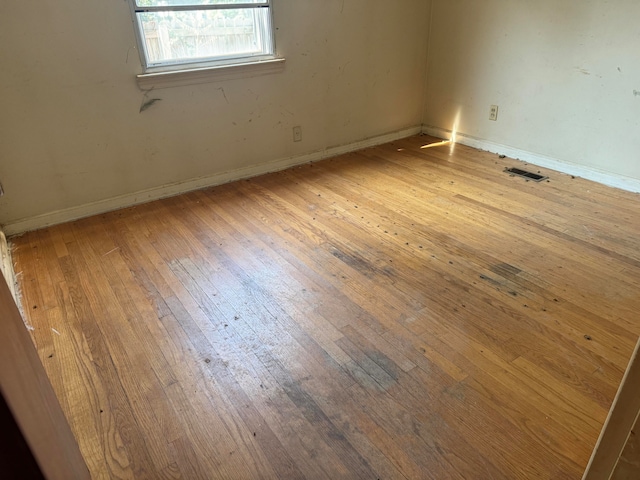 spare room featuring wood-type flooring