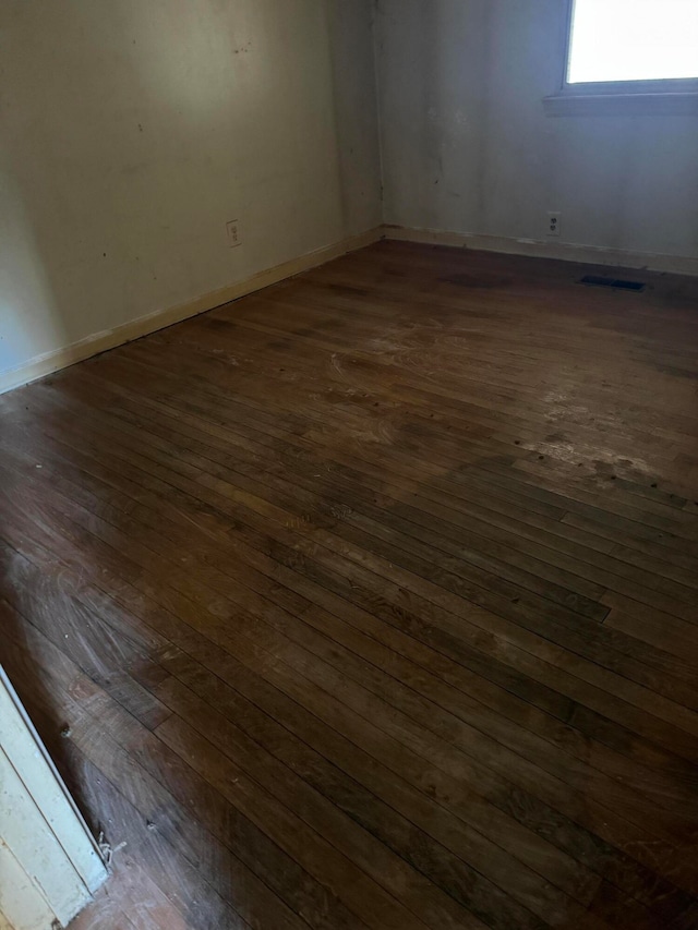 spare room with dark hardwood / wood-style flooring