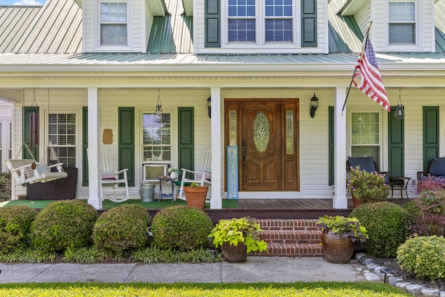 view of exterior entry with a porch