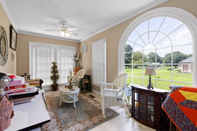 tiled living room featuring ceiling fan, a textured ceiling, and ornamental molding