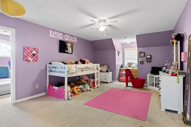 carpeted bedroom with vaulted ceiling, a textured ceiling, and ceiling fan