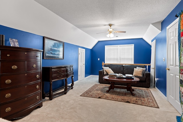 living room with light colored carpet, vaulted ceiling, a textured ceiling, and ceiling fan