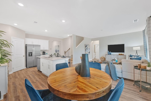 dining room featuring light wood-type flooring and sink